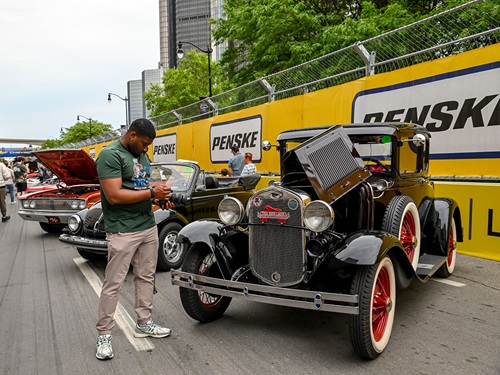 A fan inspects a car at Cruise Night