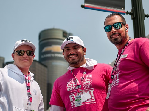 A trio of volunteers smile