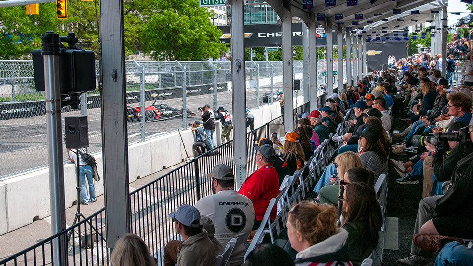 Fans watch the race from a hospitality area