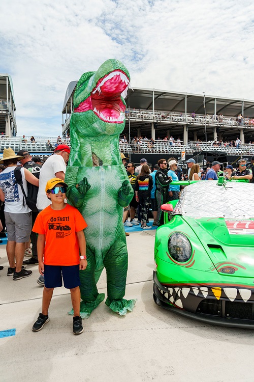 A child with a dinosaur at Chevrolet Detroit Grand Prix Presented by Lear